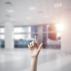 Choosing gesture of person in elegant modern interior in sunshine light