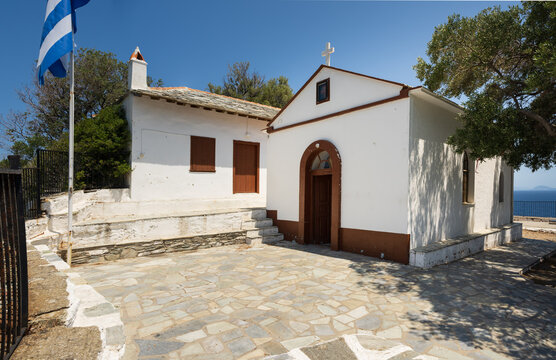 The entrance of the church of Agios Ioannis on the Mamma Mia Cliff on the island of Skopelos, shaken by the blue Mediterranean sea.