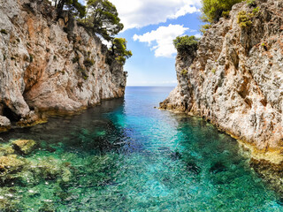 Clear turquoise sea water in the Amarandos Cove on the island of Skopelos is a reminder of a...