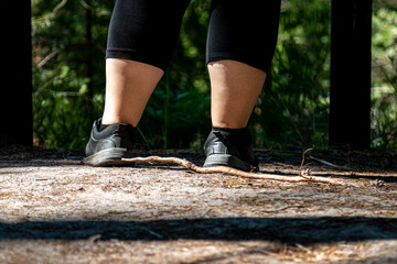 Women legs during sports in the woods. A walk in the woods. sports in the forest