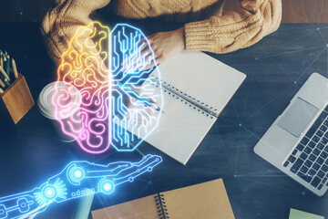 Multi exposure of writing hand on background with brain hologram. Concept of learning.