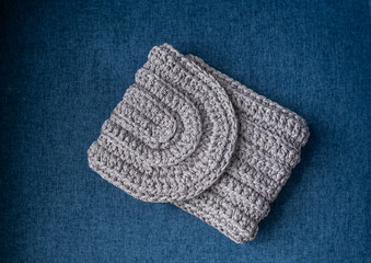 Fototapeta na wymiar Gray knitted bag. Handmade crochet purse. Closeup