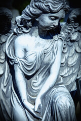 Fototapeta na wymiar An ancient statue of guardian angel (vintage style photo)