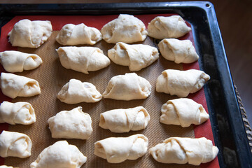Small homemade croissants in the form before baking