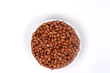 Peanuts beans in a bowl on white background