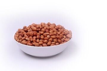 Peanuts beans in a bowl on white background