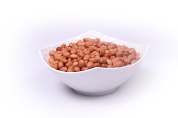 Peanuts beans in a bowl on white background
