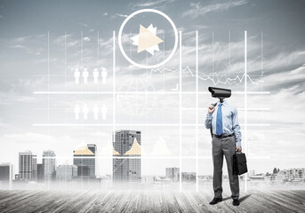 Camera headed man standing on wooden floor against modern cityscape