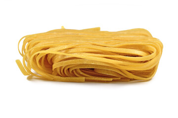Raw italian 'Tagliolini' noodles, a long ribbon pasta similar to spaghetti isolated on white background