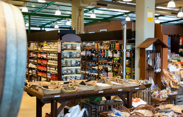 Naklejka premium Eco products store counter with large assortment of cereals, wine and other goods for sale