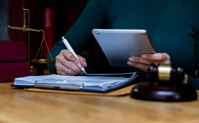 Concepts of Law and Legal services.	Lawyer working with digital tablet computer at office.