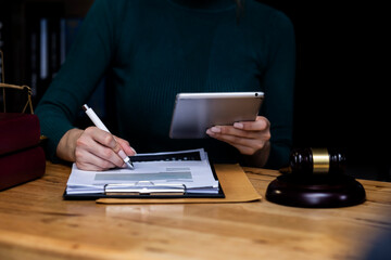 Concepts of Law and Legal services. lawyer businesswoman working on digital tablet in office.