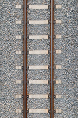 iron railroad on stones, with cement bars. Zenithal symmetrical plane. Bird's eye view.