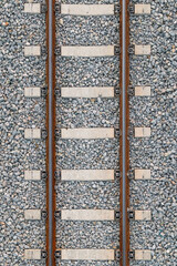 Naklejka premium iron railroad on stones, with cement bars. Zenithal symmetrical plane. Bird's eye view.