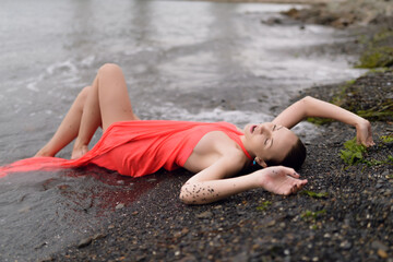 Beautiful woman in a dress on a beach.