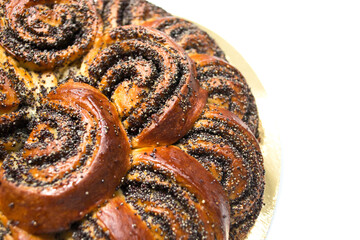 brioche with poppy seeds on white background