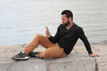Distracted man by the river, Lisbon, Portugal