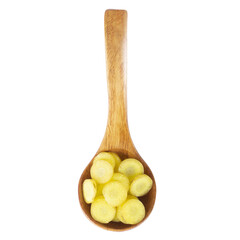 wooden spoon with slices of yellow carrot isolated on white