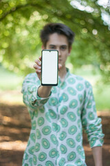 Young man showing phone screen and looking at camera