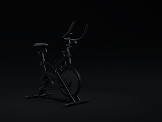 Stationary spinning bike isolated on black background. Stationary excersise bike minimal black background concept. Trainer bike black color minimalist mock up idea. 