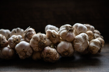 wreath of garlic on a dark wooden background