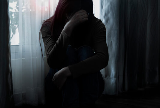 Sad young woman sitting on the bed in the bedroom, People with depression concept.	
