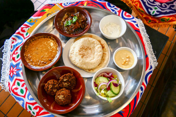 Gothenburg, Sweden  A selection hummus, falafel, salad, foul, and pita bread at an Egyptian restaurant.