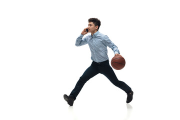 Busy. Man in office clothes playing basketball on white background like professional player, sportsman. Unusual look for businessman in motion, action with ball. Sport, healthy lifestyle, creativity.