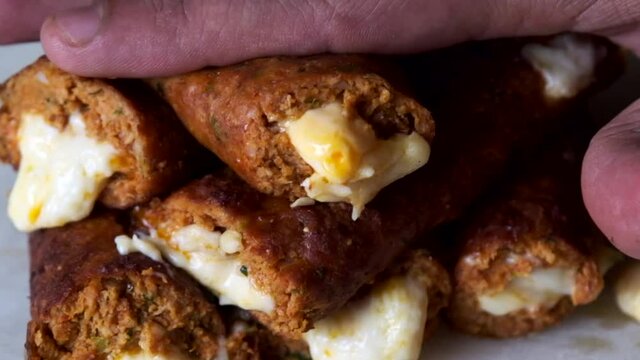 Cheese Oozing out of a kebab while its gently pressed