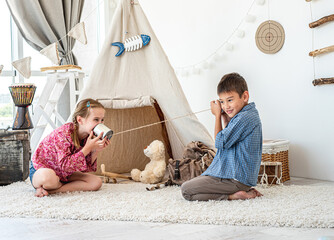 Kids playing with selfmade telephone © tan4ikk