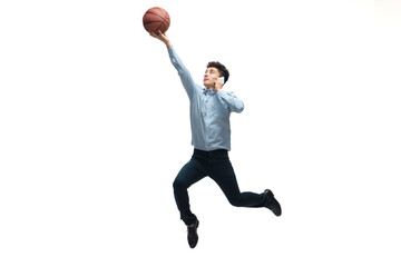 Fototapeta premium Leader. Man in office clothes playing basketball on white background like professional player, sportsman. Unusual look for businessman in motion, action with ball. Sport, healthy lifestyle, creativity