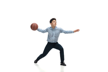 Achieves. Man in office clothes playing basketball on white background like professional player, sportsman. Unusual look for businessman in motion, action with ball. Sport, healthy lifestyle