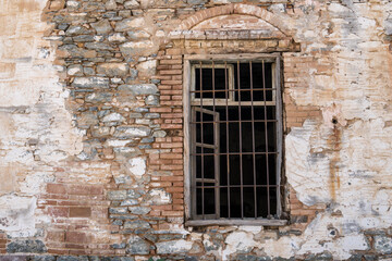 iron-barred windows historical brick wall