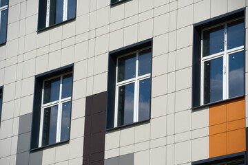 facade of a modern building on a bright Sunny day, siding and Windows, beautiful exterior of the new building