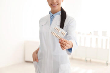 Professional pharmacist with pills in drugstore, closeup