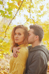 Fototapeta premium Happy young couple outdoors on a beautiful autumn day in the forest