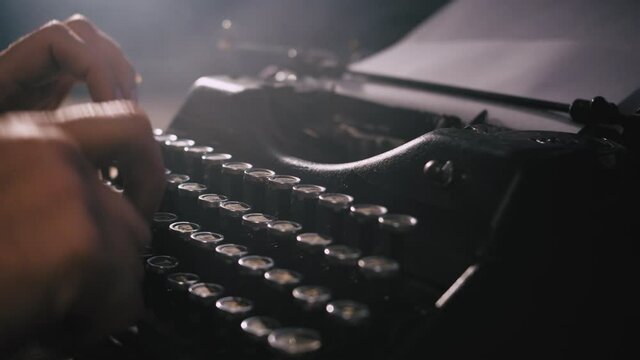 hands typing on vintage typewriter