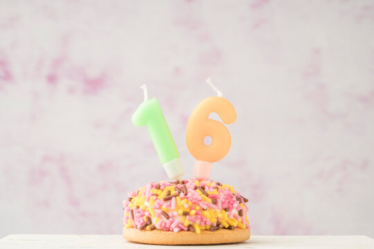 cupcake with number sixteen shaped candle for birthday