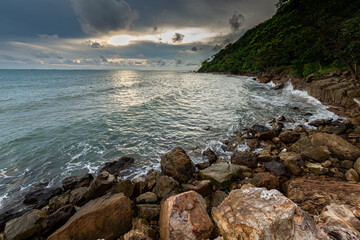 Fototapeta na wymiar Coastal Sunset, Rocky Coastline with texture of cloudy sky in Chanthaburi province, Thailand