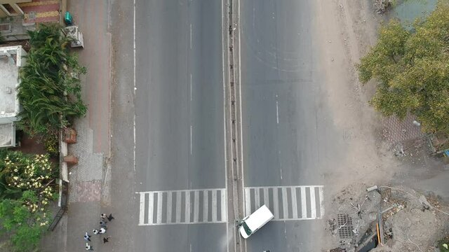 Top-down aerial drone view of the car accident site in India during lockdown due to coronavirus pandemic