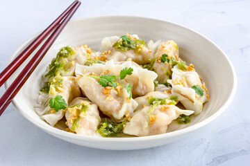 Fototapeta na wymiar Thai Dumplings / Wonton in a Bowl with Chopsticks Close Up Horizontal Photo