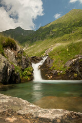 Waterfall in the mountain in a cloudy day