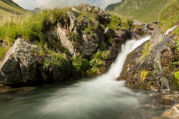 Waterfall in the mountain in a cloudy day