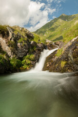 Fototapeta na wymiar Waterfall in the mountain in a cloudy day