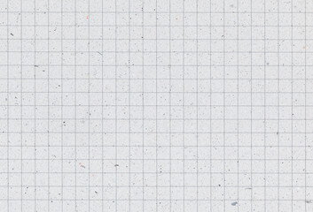 Sheet of blank grid notebook recycled paper background with inclusions of recycled paper particles....