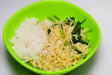 Instant noodle with mustard greens and rice. Indonesian typical food
