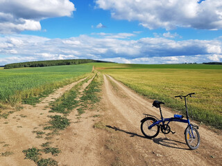 Fototapeta na wymiar The bike stands on a country road in the field