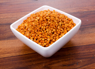 Fried and Spicy Chana Masala Dal, Chana Dal is a very popular Gujarati snack, white bowl on Wooden background