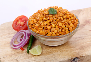 Fried and Spicy Chana Masala Dal, Chana Dal is a very popular Gujarati snack, Glass bowl on Wooden background
