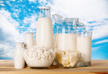 Glass of milk and dairy products on desk